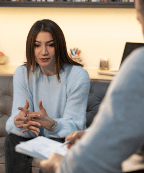 Woman talking to a therapist about rehab facility treatment programs