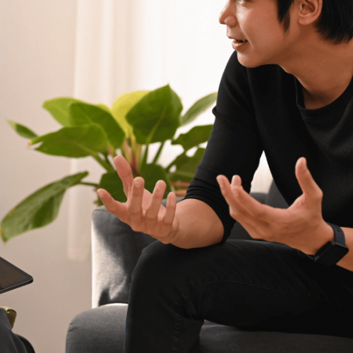 A man talking to a therapist as they discuss health insurance coverage for addiction treatment