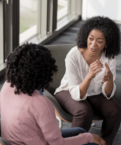 A therapist and client talk at a treatment facility for addiction rehab