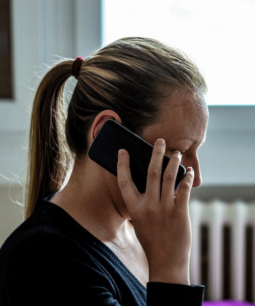 Woman calling an addiction hotline for support
