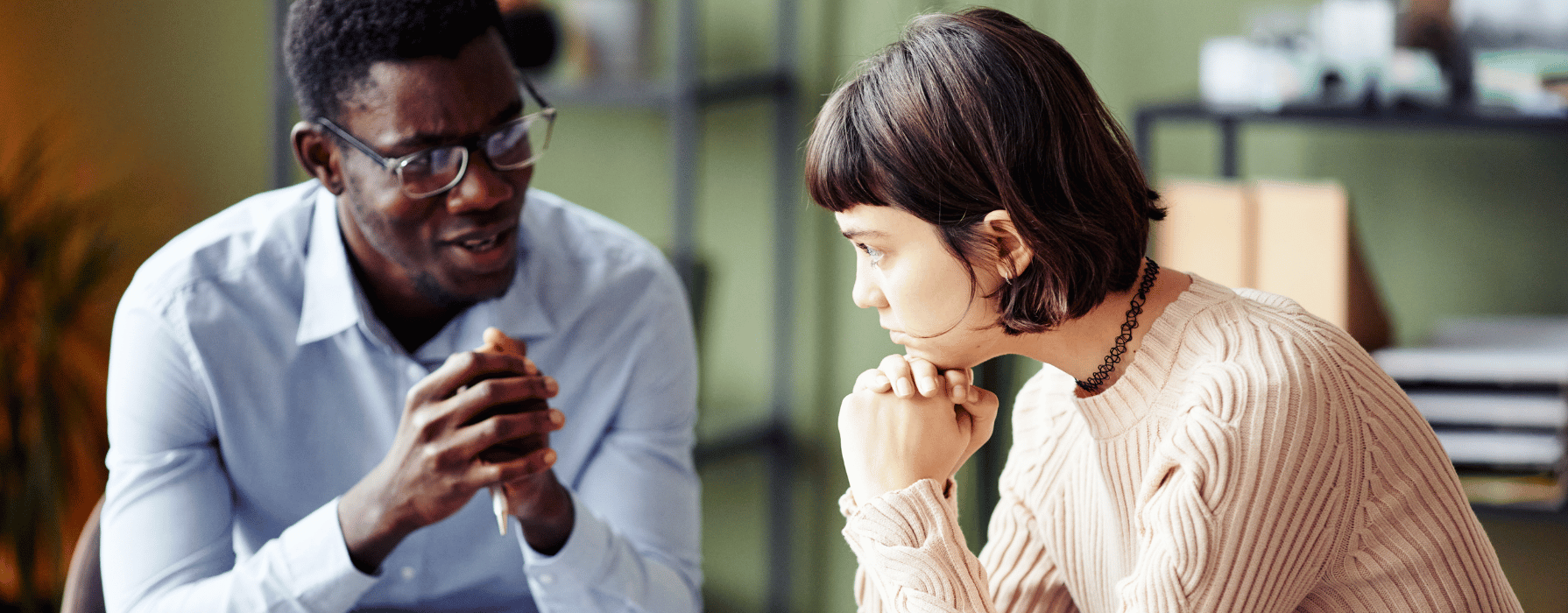 A woman listens as a therapist explains how to pay for drug and alcohol rehab