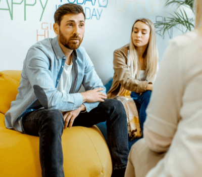 A couple meet with a therapist at a Cigna drug and addiction rehab facility