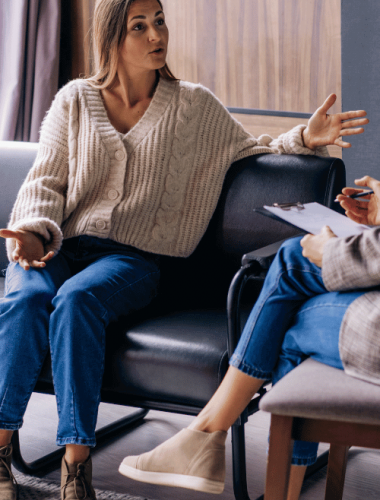 A woman and therapist discuss average cost of sober living treatment and payment options