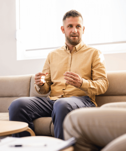 A man discusses substance addiction therapy and counseling programs with a therapist