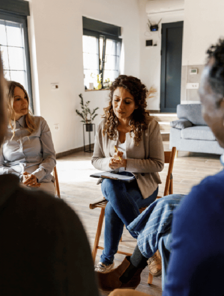 A therapist leading group therapy at an outpatient rehab facility