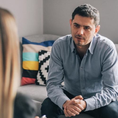 A man listens to his therapist during individual mental health therapy