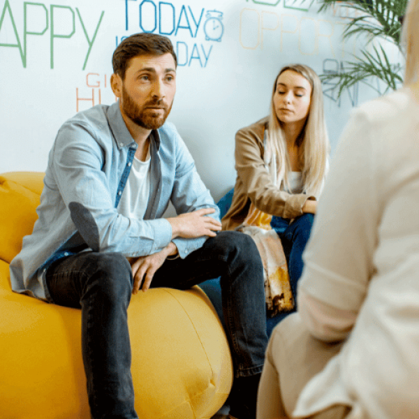 A couple meeting with a therapist about admission to a drug addiction rehab facility