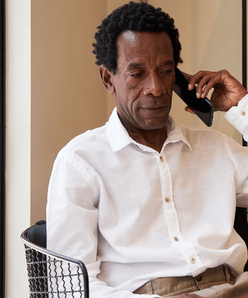 Senior man listening to a representative on an addiction recovery support line