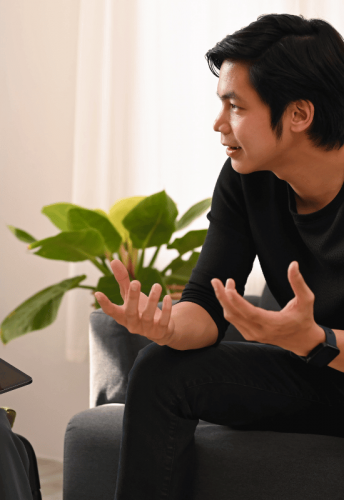 A man visiting a therapist discusses the value of paying for private drug rehab