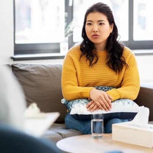 A woman talks with a therapist at a drug and alcohol rehab facility