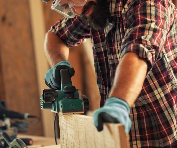A carpenter wearing goggles