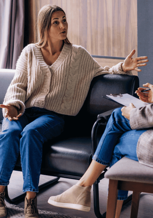 Woman talking to an addiction rehab therapist