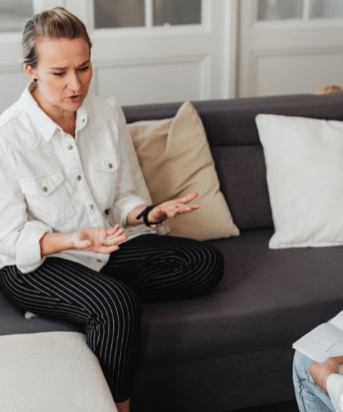 A woman talks to a therapist at a mental health and addiction rehab facility