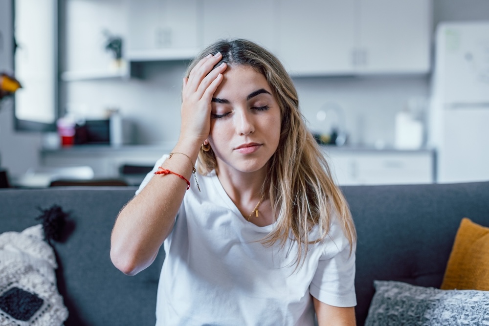Woman feeling the physical effects of alcohol addiction
