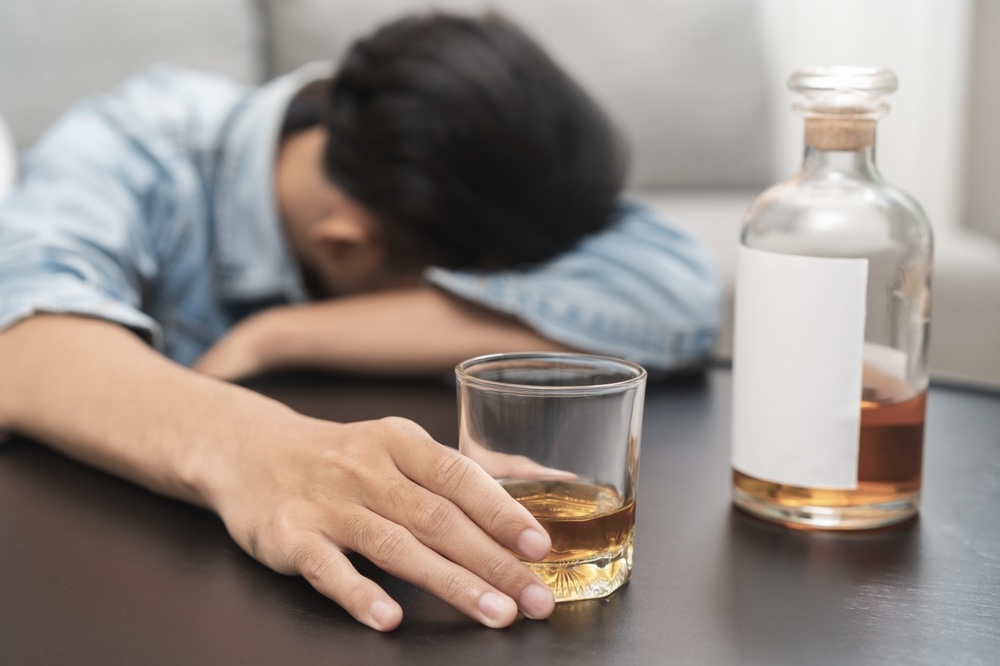 Drunk male holding a glass of alcohol