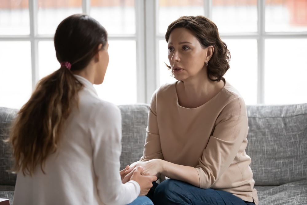 Adult daughter making amends by speaking with her mother after completing rehab