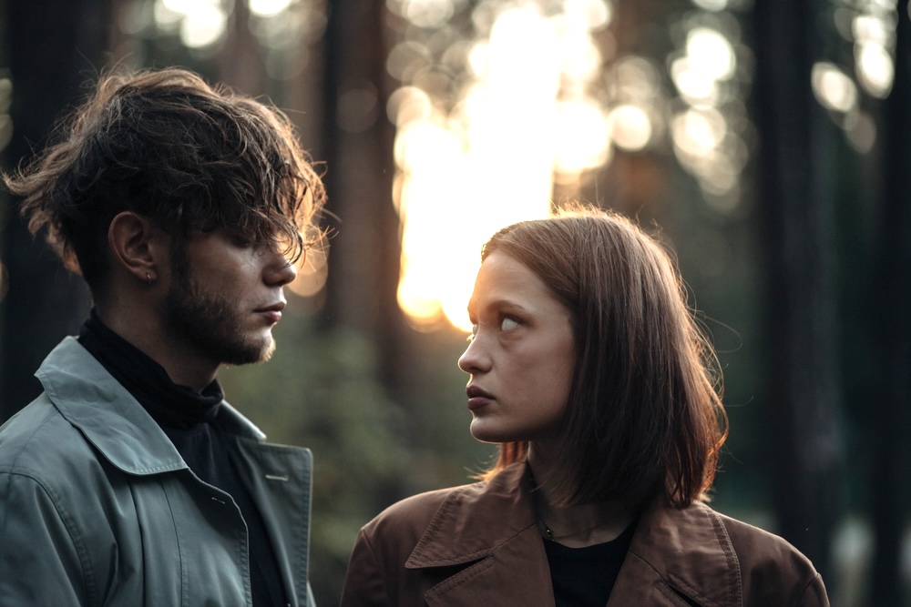 Ex-lovers looking at each other thinking if they should reconcile post rehab