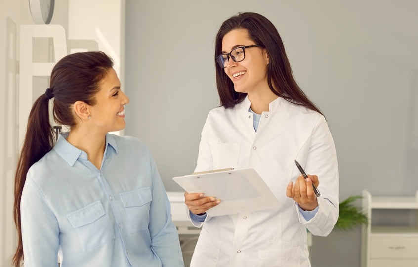 Female speaking with a staff while choosing the best rehab center